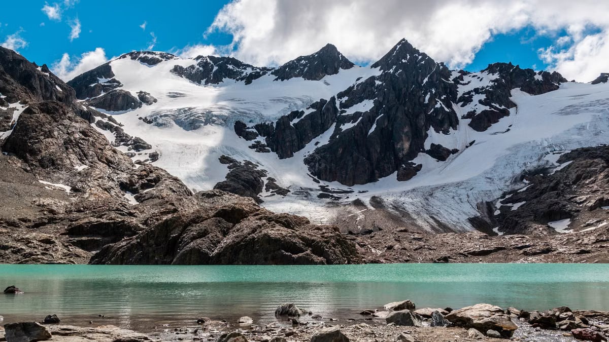 A breathtaking view of snow-covered mountains and a turquoise lagoon in Ushuaia, Argentina.